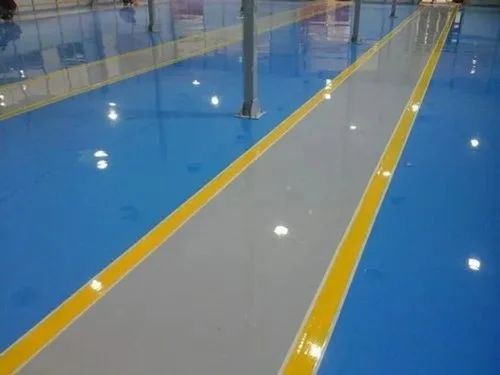 Industrial epoxy flooring — blue and grey with yellow line marking