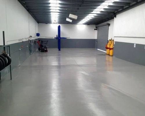 Grey epoxy flooring — automotive workshop bay