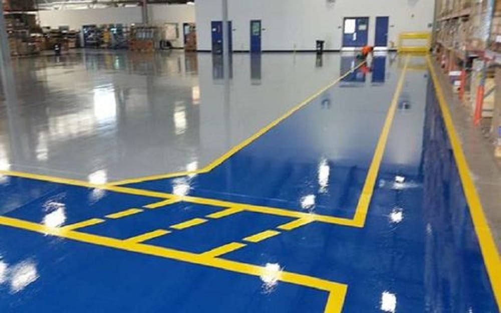 Warehouse epoxy flooring — blue floor with yellow line marking
